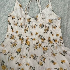 hollister brand tank top, size XS and is white with yellow flowers